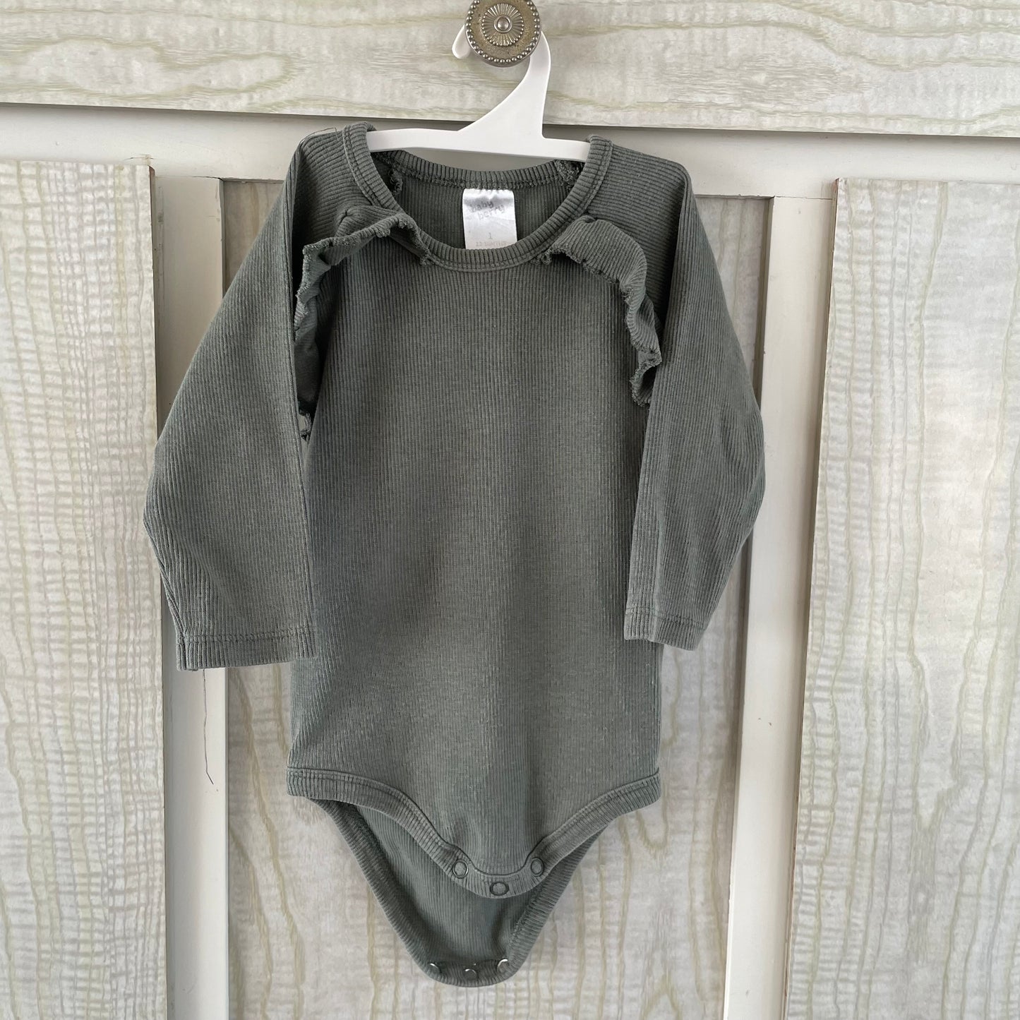 (1) green ruffle shoulder bodysuit